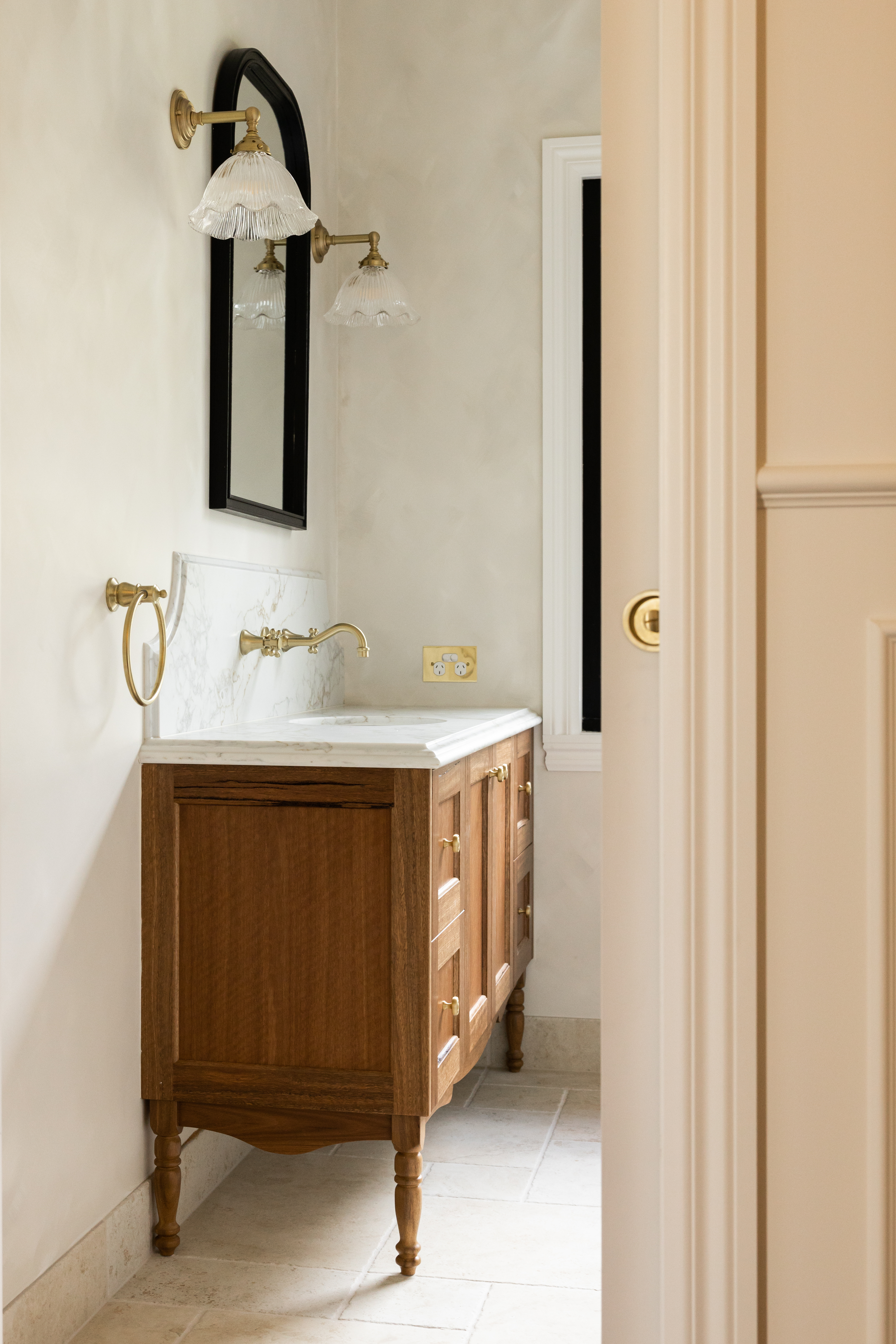 Heritage bathroom vanity with timber cabinetry and vintage-style brass fixtures